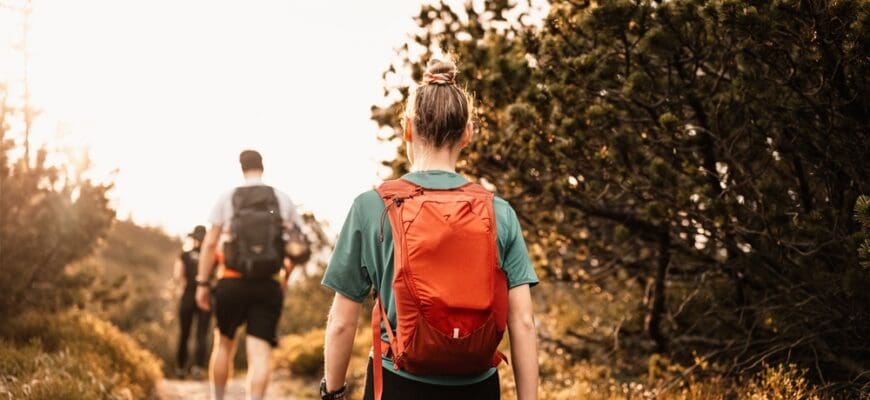 Young,Traveler,Hiking,Girl,With,Backpacks.,Hiking,In,Mountains.,Tourist