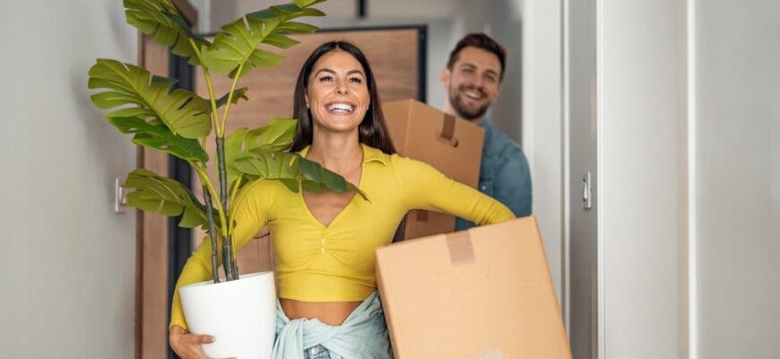 Young,Couple,Moving,In,New,Home.couple,Is,Having,Fun,With